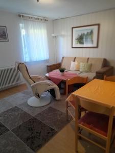 a living room with a couch and a table at Ferienhaus im Spreewald - b46731 in Straupitz