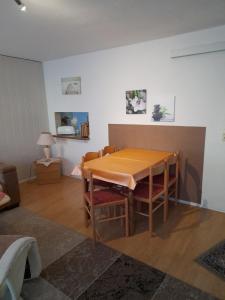 a dining room with a wooden table and chairs at Ferienhaus im Spreewald - b46731 in Straupitz