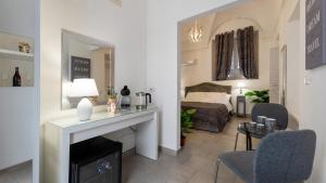 a living room with a fireplace and a bed at Duomo Luxury Suite Catania in Catania
