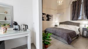 a bedroom with a bed and a table with a coffee maker at Duomo Luxury Suite Catania in Catania