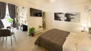 a bedroom with a bed and a living room at Duomo Luxury Suite Catania in Catania