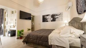 a bedroom with a bed and a television in a room at Duomo Luxury Suite Catania in Catania