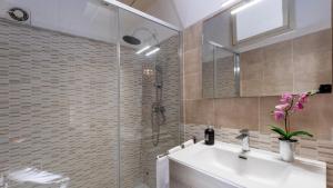 a bathroom with a sink and a glass shower at Duomo Luxury Suite Catania in Catania