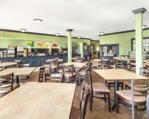 a restaurant with wooden tables and chairs in it at Quality Inn & Suites on the Beach in Corpus Christi
