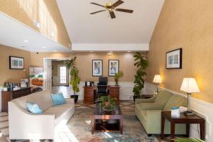 a living room with a couch and a ceiling fan at Quality Inn in Carrollton