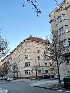 a large building with cars parked in front of it at Byt na půdě kousek od hradu in Prague