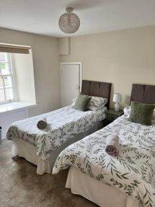 two beds sitting next to each other in a bedroom at Historic Unique Castle Apartment in Central Perth in Perth