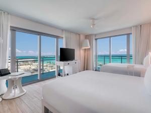 a white hotel room with a view of the ocean at SLS at Baha Mar in Nassau