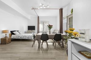 a kitchen and dining room with a table and chairs at Fréjus Base Nature in Fréjus