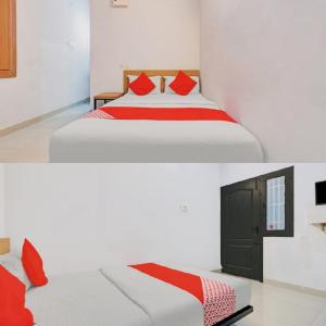 a white bed with red pillows in a room at Hotel I Plaza in Tallākulam