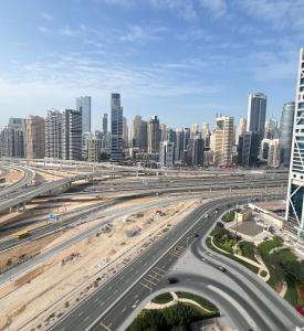 a highway in front of a city with tall buildings at Jumeirah lake towers in Dubai