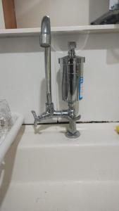 a kitchen sink with a metal mixer on a counter at Apartamento em Santa Barbara D'oeste 