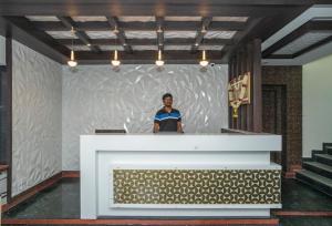 a woman standing behind a podium in a large room at HOTEL SAVI iNN in Bangalore