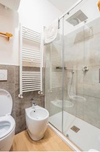 a bathroom with a toilet and a glass shower at Il Baitino Innamorato in Pragelato