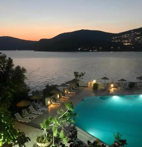 uma piscina com vista para um lago à noite em Patara Prince Hotel & Resort - Special Category em Kalkan