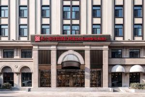 a building with a sign on the front of it at Hilton Garden Inn Beijing Temple Of Heaven East Gate Station in Beijing