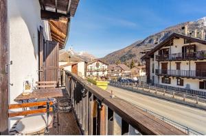 a balcony of a building with a view of a street at Il Baitino Innamorato in Pragelato