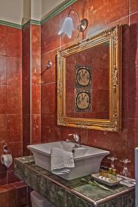 a bathroom with a sink and a mirror at Hotel Doupiani House in Kalabaka