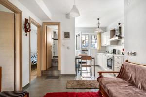 a living room with a couch and a kitchen at Sotiria House in Preveza