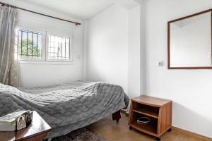 a bedroom with a bed and a table and a window at Sotiria House in Preveza