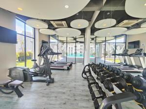 a gym with rows of treadmills and elliptical machines at Amazing Seaview 2 Bedroom Bathtub Georgetown 6-8people超级海景双房带浴缸高级公寓 in George Town