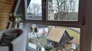 a window with a view of a house and a barn at Ferienwohnung im Traumhaus in Werda +13 photos