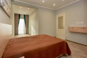 a bedroom with a large bed and a window at Sunbreeze Delux Vilas in Budva