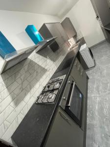 a kitchen with a stove and a counter top at Luxurious En-suite Room 4 in Manchester