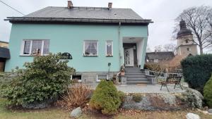 a blue house with a staircase in front of it at Traumhaus in Werda