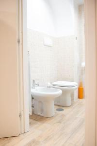 a white bathroom with a toilet and a sink at Locazione Turistica- Maxxi loft in Rome