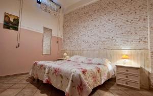 a bedroom with a bed and a brick wall at B&B Millennium in Ladispoli