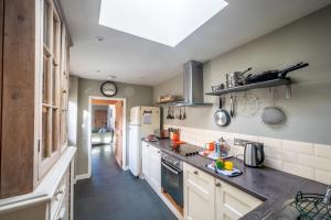 a kitchen with a sink and a counter top at Goose Cottage by Big Skies Cottages in Titchwell +9 photos