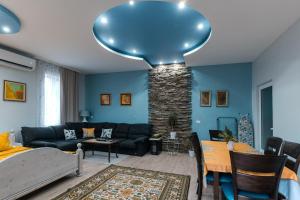 a living room with a couch and a table at Luxury Studio for 3 persons, near Carevec, Veliko Tarnovo in Veliko Tŭrnovo