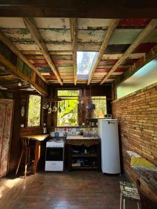 uma cozinha com um fogão e um frigorífico em Casa Barco Campeche em Florianópolis
