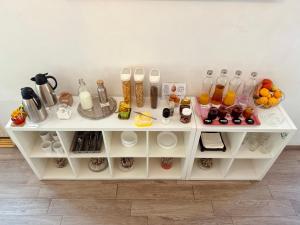 a white shelf with food and drinks on it at Firmeza 358 studios - street level in Porto +5 photos