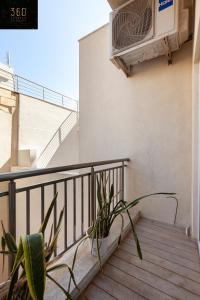 a balcony with a heater and a plant at Lovely 2BR home in St Julians with Private Balcony by 360 Estates in St. Julianʼs