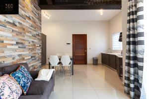 a living room with a couch and a kitchen at Lovely 2BR home in St Julians with Private Balcony by 360 Estates in St. Julianʼs