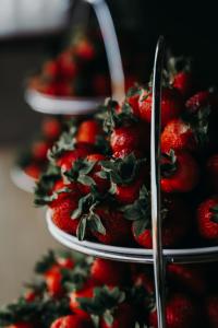 a bunch of strawberries on a plate with tongs at Valgeranna puhkekeskuse hotell in Valgeranna