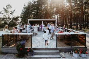 a wedding reception on a deck in the woods at Valgeranna puhkekeskuse hotell in Valgeranna