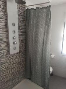 a shower with a shower curtain in a bathroom at Casa para relajarse, con vistas. in Caravaca de la Cruz