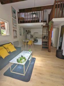 ein Wohnzimmer mit einem Sofa und einem Tisch in der Unterkunft Maison individuelle avec jardin ensoleillé in Auribeau-sur-Siagne
