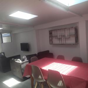 a conference room with a red table and chairs at Gîte Timadam in Cilaos