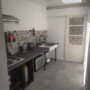 a kitchen with a sink and a counter top at Gîte Timadam in Cilaos