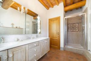 a bathroom with a sink and a shower and a mirror at Agriturismo La Valle A Polvereto in Tavarnelle Val di Pesa +121 photos
