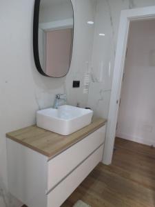 a bathroom with a white sink and a mirror at Apartamento AIRES DEL NORTE, con WiFi gratis in Santander