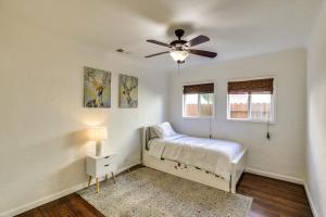 a bedroom with a bed and a ceiling fan at Spanish-Style Long Beach Bungalow Near Beaches! in Long Beach