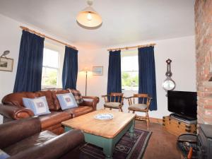 a living room with a couch and a table at 2 bed in Binham 26324 in Binham