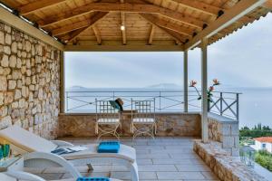 a patio with a view of the ocean at Infinite Blue Epidavros in Ancient Epidavros