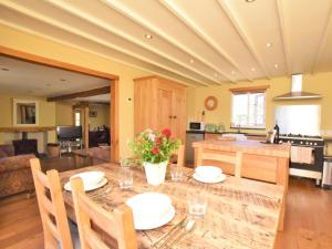 a dining room and kitchen with a table and chairs at 2 Bed in Croyde GCOWS in Marwood