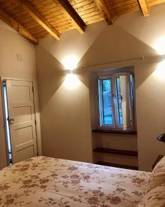 - une chambre avec un lit, une fenêtre et des lumières dans l'établissement Casa do Ti'Xico, à Aljustrel